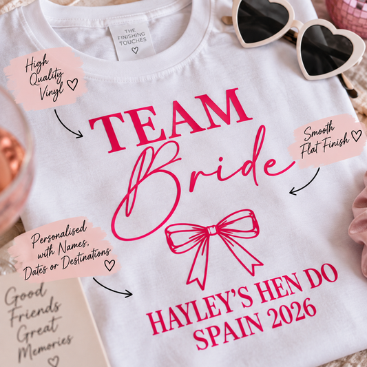 Close-up of personalised Team Bride hen party T-shirt with smooth flat pink vinyl, custom bride name, Spain destination and date.