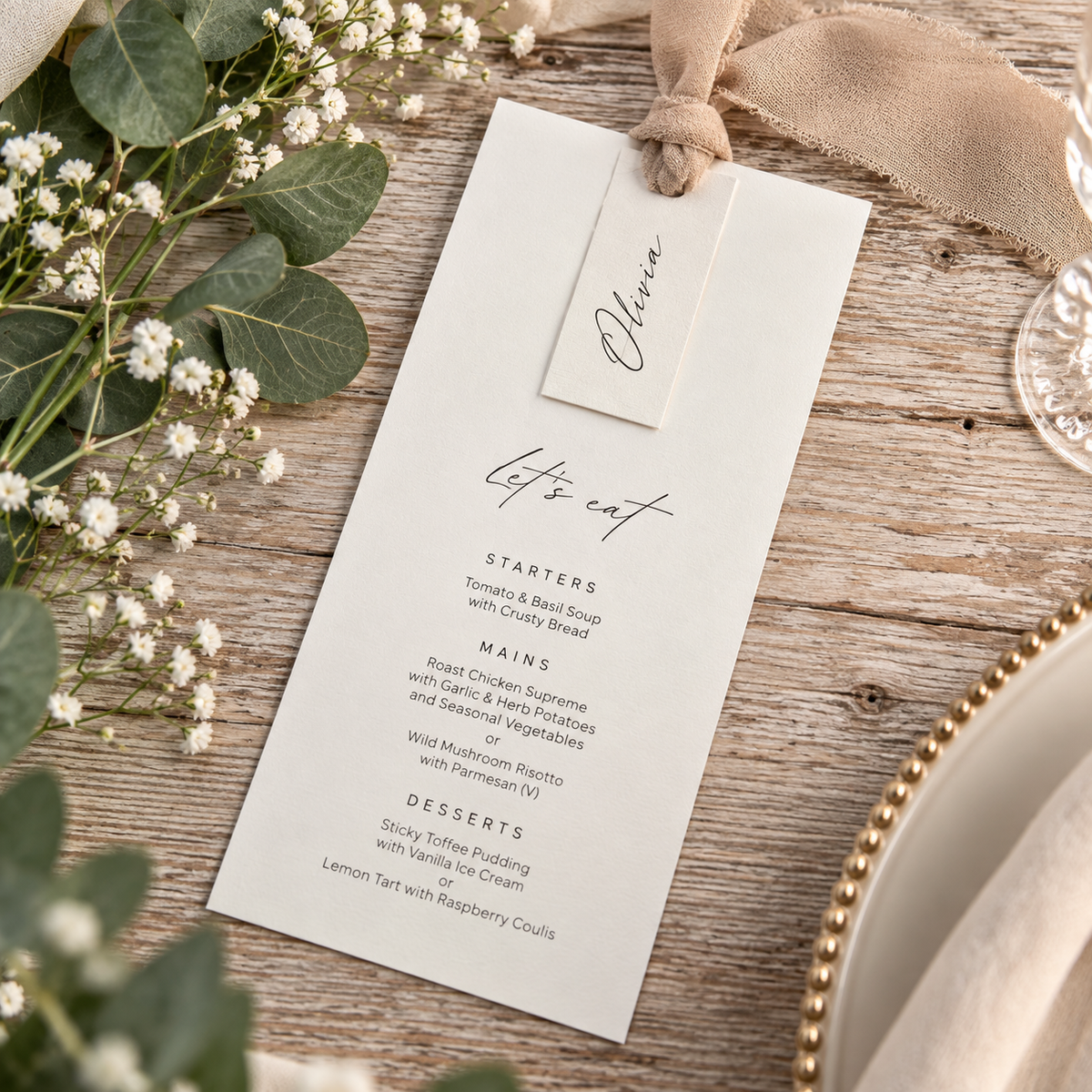 Personalised wedding menu with individual guest name tag and taupe ribbon styled on an elegant wedding table.
