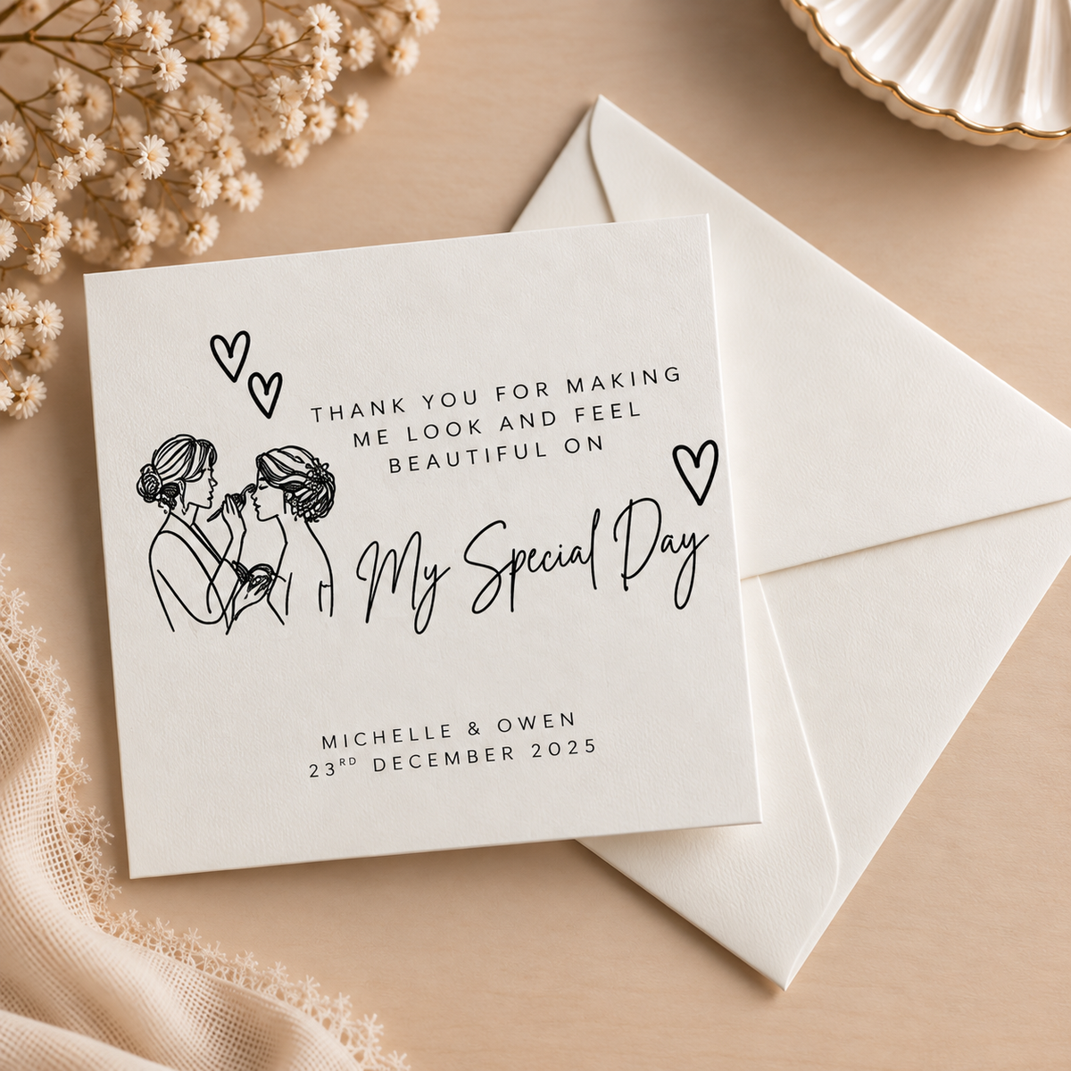 Personalised wedding vendor thank you card styled with elegant bridal accessories, flowers and envelope in a neutral wedding setting.